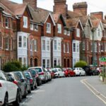 Victorian-style houses and parked cars on a curved street in Royal Tunbridge Wells, UK.